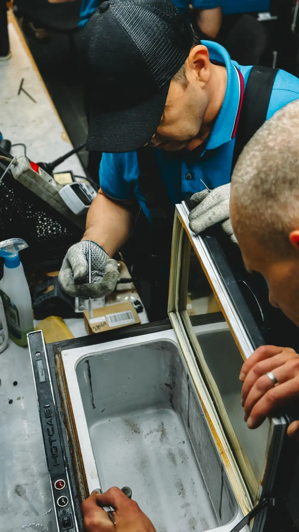 Refrigerator repair technician working in an Alberta Arts District, Portland home